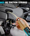 Duratech 500cc oil suction syringe with long hose and extension tubes held in front of car engine bay