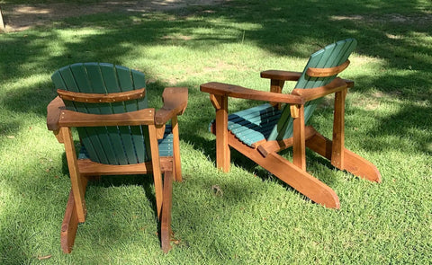 Classic Adirondack Chair Plans With Full Size Templates, two wooden chairs on grass, featuring green slats and brown frames.