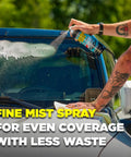 Person using Top Shelf Foaming Auto Glass Cleaner on windshield for streak-free shine, 19 ounce spray can in hand.