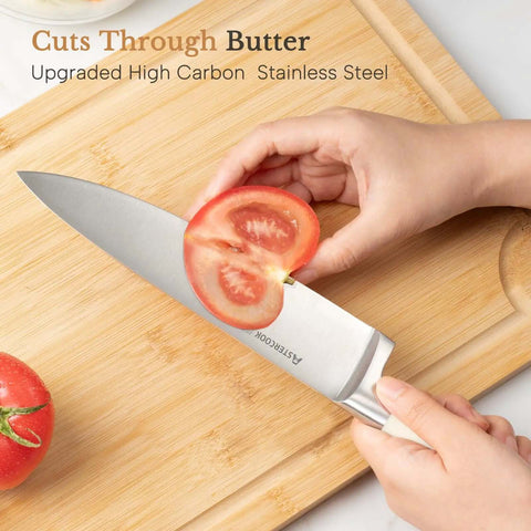Slicing tomato with 14 Piece Full Tang Kitchen Knife Set With Wood Block Sharpener, high carbon stainless steel blade on cutting board