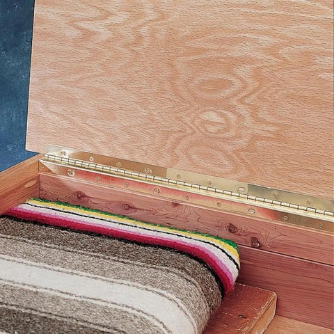 Heavy Duty Brass Plated Partial Wrap Slotted Piano Hinge Built Like A Truck For Doors And Lids installed on a wooden cabinet with patterned fabric.