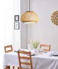 Retro Bamboo Dome Flush Mount Ceiling Light With Adjustable Cord Up To 23.62 Inches over dining table with white tablecloth.