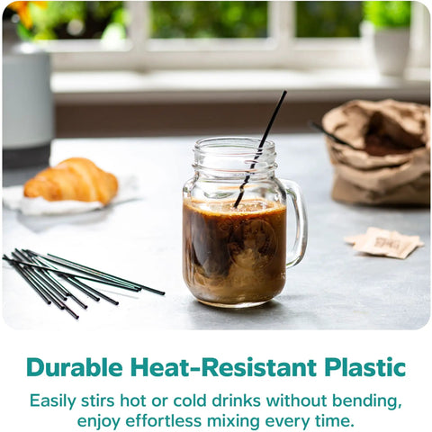 7 Inch Black Disposable Stir Sticks For Hot And Cold Beverages in glass jar with iced coffee on table