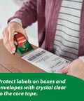 Person using dispenser with Six Rolls Heavy Duty Clear Packing Tape Dispenser Bundle For Shipping And Moving on a box