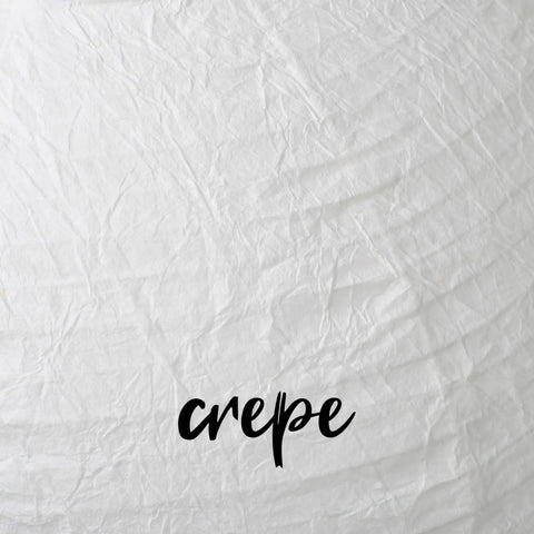 Close-up of crepe paper texture on oval lantern, showing handcrafted detail, part of Oval Crepe Paper Lanterns 22 Inch Two Pack For Indoor Ceiling Decor.