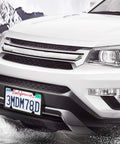 Lock Your Plates Down Tight With These Sleek Black License Plate Screws Featuring Tamper Proof Anti Theft Design Made From Sturdy One Quarter Inch Stainless Steel For Quick Install And Heavy Shield Against Highway Hooligans And Dust on a white SUV with a California license plate.