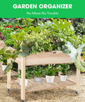 Elevated Wooden Raised Garden Bed On Wheels With Storage Shelf And Protective Liner Outdoor Planter Box with plants on display