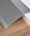 The Heavy Duty Aluminum Transition Strip 36 Inch Doorway Ramp Reducer For Wheelchair Thresholds Smooth Ride Aviation Solid Gray Aluminum Flooring Quick Install on wooden floor.