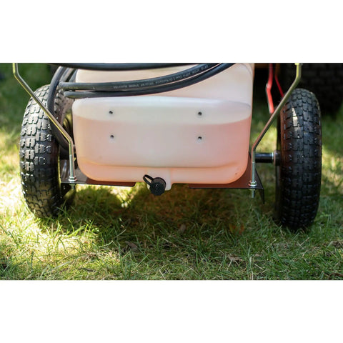 Rear view of Tow-Behind Garden Sprayer With 15 Gallon Tank, 30 Inch Boom, 1.6 GPM At 100 PSI on grass, focusing on wheels and tank outlet.