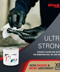 Close-up of PowerClean X80 Heavy Duty Cloths And Wipes Jumbo Roll 455 Sheets with gloved hands cleaning oil and grime