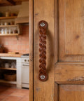 Leather Drawer Pulls Braided Cognac Finish Set Of 12 attached to a rustic wooden cabinet in a kitchen setting
