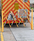 Expandable 8.46ft Safety Barricade With Water Filled Weighted Base in use on city street with retractable design visible