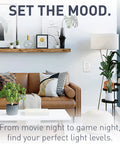 Living room with Radiant LED Dimmer Rocker Switch for home lighting on wall, brown sofa, plants, and decor