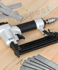 No Sweat 1609 Piece Pneumatic Staple And Nail Bundle Featuring 18 Gauge Narrow Crown Staples Plus 5/8 Inch Brad Nails With Rust Resistant Galvanized Finish And Sturdy Carry Case To Bang Out Any Home Project Or Construction Task - Pneumatic staple gun and galvanized staples on wooden surface.