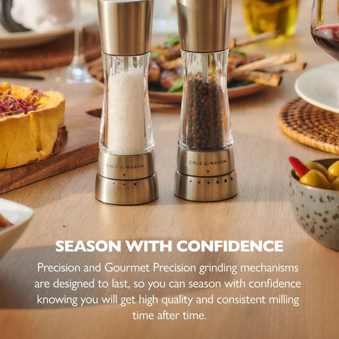 Stainless steel pepper grinder and salt mill on table, Pepper Grinder With Adjustable Six Level Grind, Stainless Steel Mill.