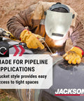 Worker welding pipeline wearing PL280 Pipeline Welding Hood With Shade 10 Flip Front, ANSI Z87.1, Made In USA, fiberglass helmet