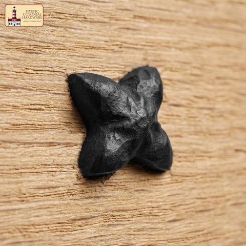 Colonial Era Solid Cast Iron Decorative Nailhead Studs For Doors, Cabinets And Furniture in rustic black on wood surface