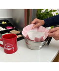 Person placing 0.9 Ounce Caffeine Regular Filter Pack For Easy Premeasured Brews into coffee machine next to red mug on counter
