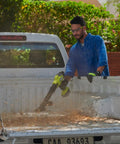Man using 18V One Plus Brushless Compact Blower Bare Tool With Variable Speed Trigger And Lock On to clean truck bed