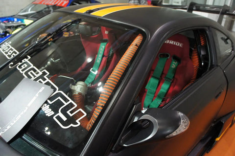 Interior view of a race car with SCAT Flex Duct Silicone Impregnated Fiberglass With Steel Wire Reinforcement For Intake, red highlights.