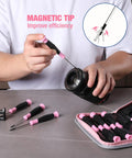 Person using Slick 10 Piece Precision Screwdriver Set With Ergonomic Comfort Grip And Sturdy Pink Pouch for camera repair.