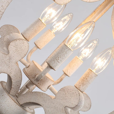 Close-up of white French country five-light chandelier with antique distressed wood cozy farmhouse rustic pendant light.
