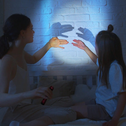 Child making shadow puppets on wall using Ultra Bright LED Flashlight With 180 Lumens, 150 Meter Beam, Compact Water Resistant EDC Light For Home Security, Camping And Everyday Carry, Pink Finish
