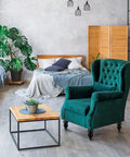 Stylish living room with green armchair, wooden table, and bed. 10 Inch Wood Furniture Legs Set of 4 in Variegated Natural Wood Grain.