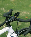 Out Front Bike Computer Mount For Garmin Edge GPS Devices on black handlebars of a white road bike