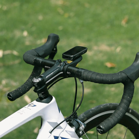 Out Front Bike Computer Mount For Garmin Edge GPS Devices on black handlebars of a white road bike