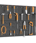 Four Piece Twelve By Sixteen Inch Metal Pegboard Panels Built Tough For Your Garage, Workbench And Shop, Modular Wall Mounted Pegboard With One Eighth Inch And One Quarter Inch Holes, Black displaying tools organized on a wall