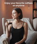 Woman enjoying coffee in a cozy chair, highlighting the Top Shelf Automatic Espresso Machine With Built In Grinder And Touch Panel For Fire Lattes And Creamy Cappuccinos Fuel Daily Sips At Twenty Bar Across Fifteen Settings With Effortless Self Cleaning.