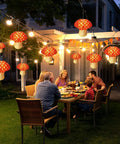 Six Pack Mushroom Paper Lanterns Set For Party Decor And Nursery Ornaments 3D Woodland Mushrooms For Garden Christmas Or Halloween Tables Easy To Assemble And Hang Orange Red Color lighting up an evening garden dinner.