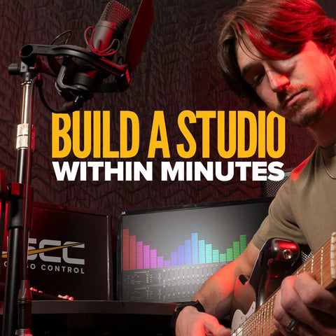 Musician playing guitar in studio with sound equipment and microphone, promoting massive studio ready 96 by 80 inch sound dampening blanket.
