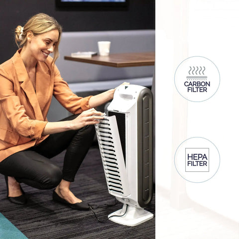 Woman adjusting AeraMax 100 Air Purifier With True HEPA Filter And Four Stage Purification in small room.