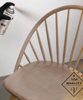 Applying Premium Antique White Oil Based Wood Stain Spray to a wooden chair, showcasing intricate areas and a smooth finish.