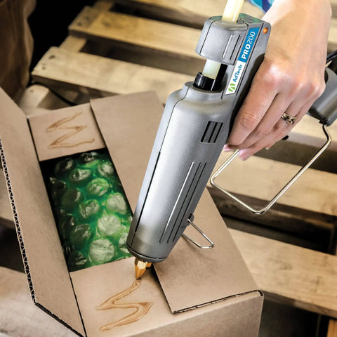 Heavy Duty Full Size High Output Hot Melt Glue Gun Pro Grade For Carpentry Repairs And Remodeling Grey 200 Watts DIY Ready Comfort Grip Trigger Ergonomic Design used on cardboard box