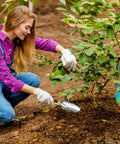 Woman gardening with Heavy Duty Aluminum Garden Shovel And Trowel Set With Soft TPR Handle Metal Hand Spade