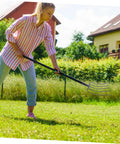 Person using Heavy Duty Handheld Manure Fork For Farming And Gardening A Real Workhorse Solid Iron Grass Fork on lawn