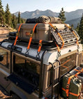 Beefy Ratchet Tie Down Straps 2 Pack 1 Inch By 15 Feet securing cargo on a vehicle rooftop with locking hooks and rubberized handles.