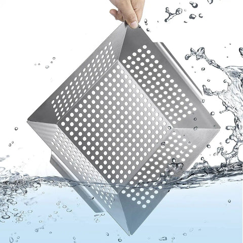 Hand holding stainless steel grill basket under water, highlighting durability. Stainless Steel Grill Basket For Indoor And Outdoor Use Large 12 By 12 By 2 Inch Veggie And Kabob Grilling Basket Heavy Duty Dishwasher Safe For All Grills Grill Like A Boss For All Skill Levels.