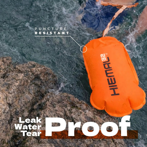 Open Water Swim Buoy With 15L Dry Bag and Rest Handle, Fully Waterproof Swim Bubble in orange on water surface