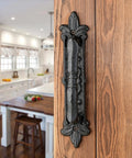 4 Pack Heavy Duty 8.9 Inch Black Cast Iron Barn Door Handle on Wooden Door in Rustic Interior Kitchen Setting