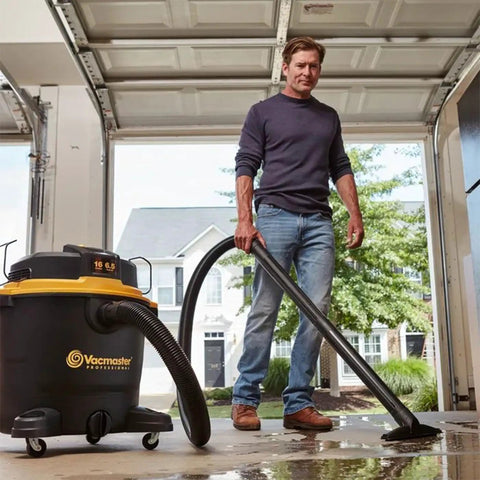 Man using Beast Series 16 Gallon Wet/Dry Shop Vac With 6.5 HP Motor, Beast Mode 360 Air Watts Suction in a garage setting.