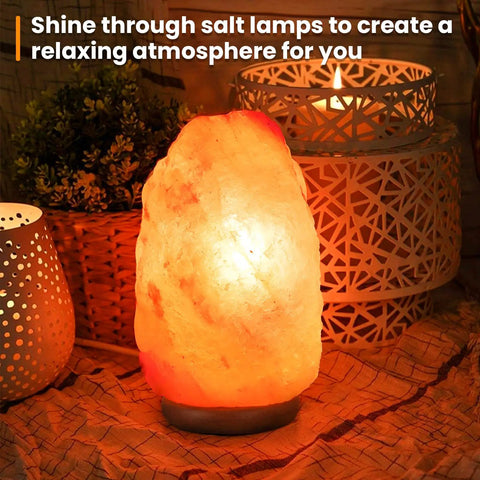 Illuminated Himalayan salt lamp on table with decorative candle holders and plants creating a relaxing atmosphere.