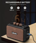 Portable 5W Mini Guitar Amplifier With Dual Speakers, Rechargeable Bluetooth Practice Amp charging on desk, brown finish