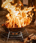 Hexagonal 430 Stainless Steel Folding Fire Pit Burn Barrel For Wood Fires in use outdoors with flames and log pile nearby