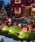 Outdoor Solar Spotlight Kit With 18 LED Ultra Bright Lights illuminating holiday decorations in snowy garden