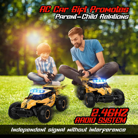 Father and son playing with Monster 1 To 12 Scale RC Truck with LED Headlights in park, showcasing 2.4GHz remote control feature.