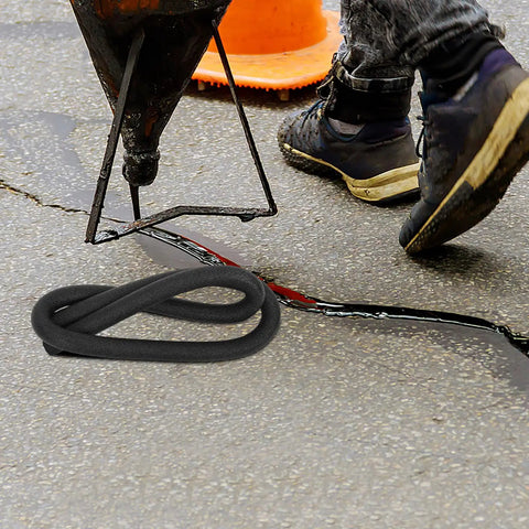 Top Shelf Black Foam Backer Rod And Gap Filler For Expansion Joints And Cracks beside a worker sealing pavement cracks.